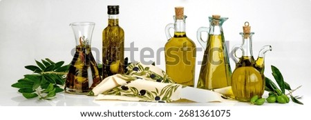 Extra virgin olive oil in different type of bottles and decorative elements composition on white background.