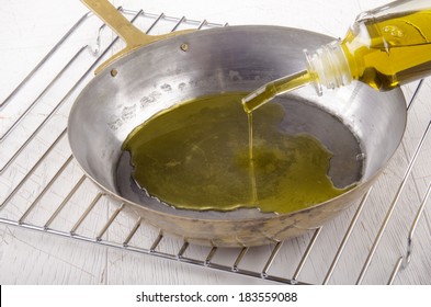 Extra Virgin Olive Oil Is Poured Into A Pan