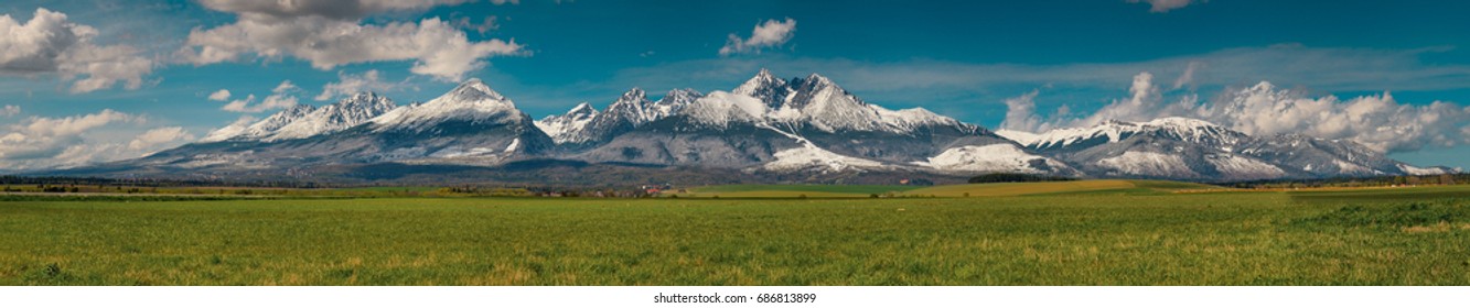 Extra wide panorama of High Tatra mountains during April with snowy hills / Vysoke Tatry / Slovakia