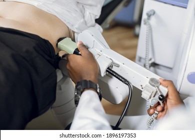 Extracorporeal shockwave therapy in urology. Cropped shot of belly of woman patient, having ultrasound to determine kidney stones position before the lithotripsy procedure.
