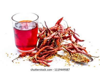 Extracted or tincture of Red pepper or red chilies with its flakes isolated on white. - Powered by Shutterstock