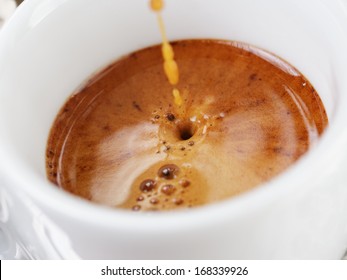 Extraction Of Espresso With Rich Crema In Cup, Close Up Photo