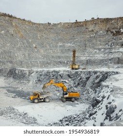 Extraction Of Slate In The Winter In A Quarry, Drilling Of Wells Before Blasting And Loading Of A Dump Truck With The Extracted Rock.