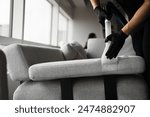 Extractor cleaning removes dust from the sofa at home. Dry-cleaning the upholstery furniture fibers with extractor
