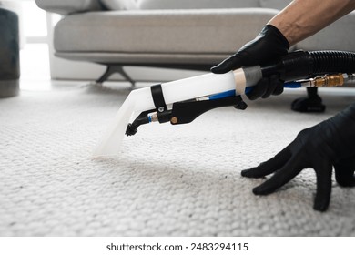Extractor washing of carpet. Cleaner is using extractor to clean the carpet at home. Using extractor to wash off the carpet from dust and stains