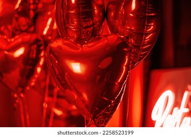 Extravagant bedroom luxury interior with love glamur decoration at Valentine day in studio. Balloons by heart shaped and at illuminated mirror romantic cozy atmosphere at vivid red background.  - Shutterstock ID 2258523199