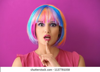 Extravagant young woman on color background