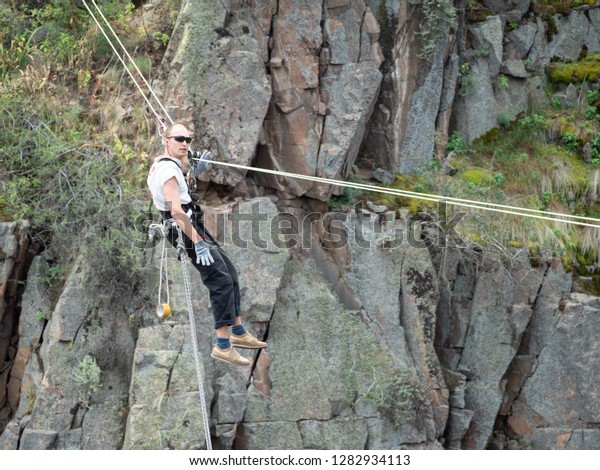 An extream sportman jumps in a rope
on a big hight. Danger sport, bungee/rop
jumping.