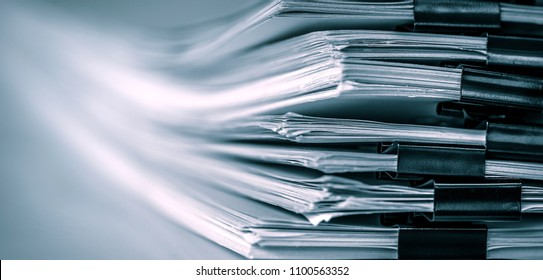 extreamely close up a report paper stacking of office working document , retro color tone - Shutterstock ID 1100563352