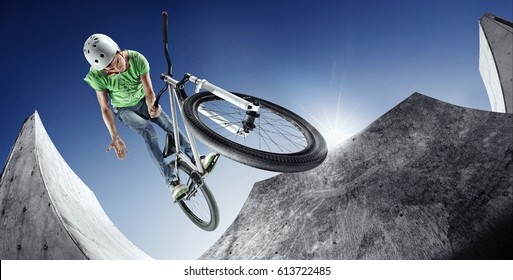 Extrem Sport. Boy jumping with his street-bike in the extrme park. - Powered by Shutterstock