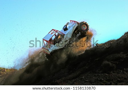Extreme 4x4 vehicle jumping a dune