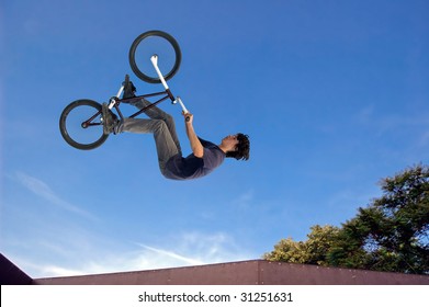 Extreme bicycle rider performing dangerous jumps with his bike. - Powered by Shutterstock