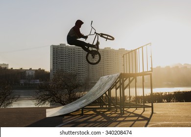 Extreme Bike Rider Jumping In Moscow Skate Park At The Sunset