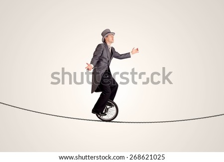 Extreme business man riding unicycle on a rope concept on background