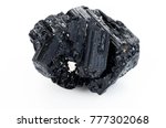 extreme close up of black tourmaline mineral isolated over white background in focus stacking technique