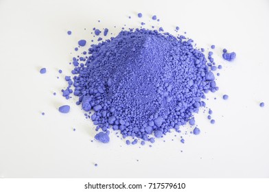 Extreme Close Up Of Bright Ultramarine Pigment Isolated Over White Background