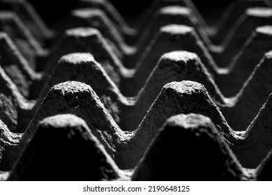 Extreme Close Up Of An Empty Cardboard Egg Tray. Dark Mood, Abstract, Monochromatic Image Of The Texture And Pattern Of A Carton. Selective Focus And Shallow Depth Of Field.