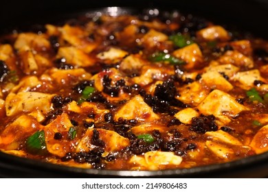 extreme close up Mapo tofu in plate. Popular Chinese dish from Sichuan. Tofu set in a spicy sauce