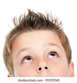 Extreme Close Up Portrait Of Boy Looking Up.Isolated On White.