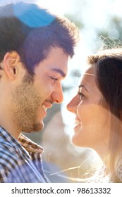 Extreme Close Up Portrait Of Romantic Couple Looking At Each Other Outdoors.