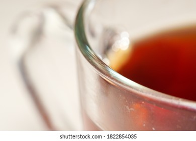 Extreme Close Up Of The Rim Of A Transparent Glass Cup Of Tea.