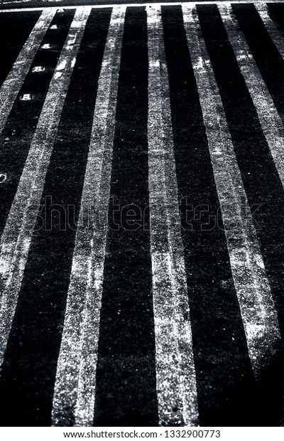 Extreme close up shot of cross walks or zebra\
crossing on roads.
