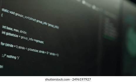 Extreme close up shot of lines of code displayed on computer monitors used by cybercriminal stealing sensitive information. Virus scripts running on PC infecting network systems, breaking passwords