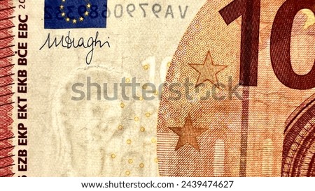 Extreme close-up of a 10 Euro banknote, showcasing intricate patterns, watermark, and signature.