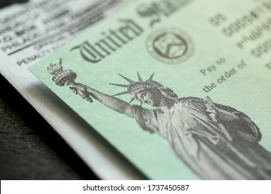 Extreme close-up of Federal coronavirus stimulus check provided to all Americans from the United States Treasury in 2020 and 2021, showing the statue of liberty.  - Shutterstock ID 1737450587