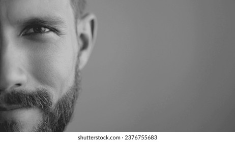 Extreme close-up, headshot half face of a confident young man 30s. Advertisement of skin care, facial care products for men. Isolation background, slow motion, copy space. Black white image. - Powered by Shutterstock