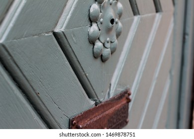 Extreme Closeup Of Old Medival Wooden Door Painted Light Blue Wirth Brass Trimmings In Downtown Hannover, Germany