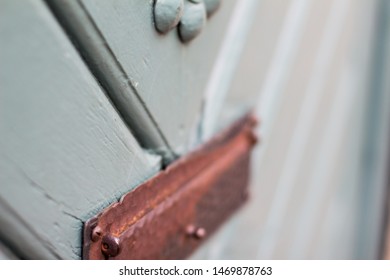 Extreme Closeup Of Old Medival Wooden Door Painted Light Blue Wirth Brass Trimmings In Downtown Hannover, Germany