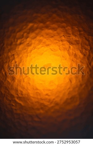 Extreme closeup of a plasic rough surface lid up by light from the back