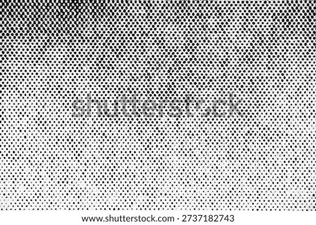 Extreme close-up of printed halftone pattern showing a vertical gradient of black dots becoming denser toward the top of the white paper.