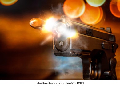 Extreme Close-up Shot Of The 9mm Bullet Coming Out Of The Gun Barrel. 