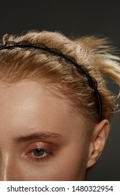 Extreme Close-up Shot Of A Young Blonde European Girl With A Black Hairband Made In The Form Of A Figured Spiral Spring Twining Around The Wire In Her Hair. The Fashion Model With Nude Make-up 