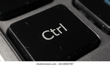 Extreme close-up of a single "Ctrl" key on a computer keyboard. Shows texture and detail.
