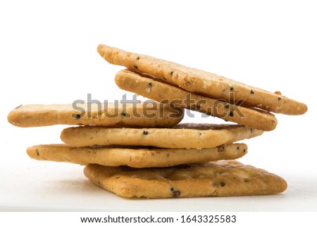 extreme closeup of a stack of multigrain crackers isolated on white
