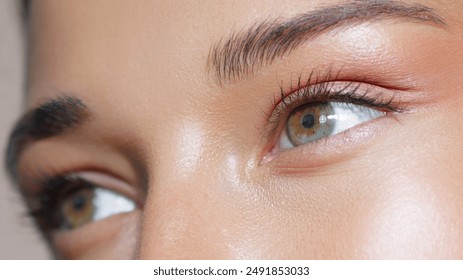 Extreme close-up of a woman's green eyes with perfect makeup, showcasing detailed eye beauty and skincare. Ideal for makeup and beauty promotions, high-quality advertisements, and conceptual beauty