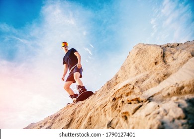 Extreme descent sand on snowboard in desert. Male snowboarder on dunes. - Powered by Shutterstock