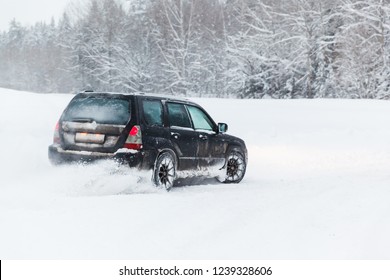 Extreme Driving, The Car Is Moving Rapidly Over The Smooth Snow And Creates A Spray Of Snow.