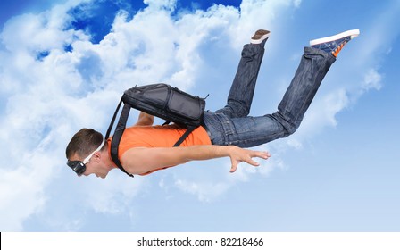 Extreme flight man with a parachute in the clouds