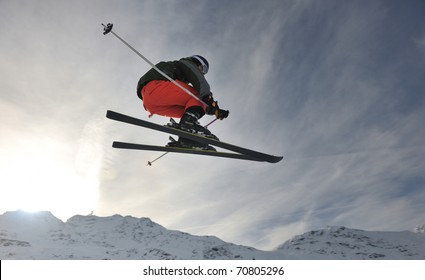 Extreme Freestyle Ski Jump With Young Man At Mountain In Snow Park At Winter Season