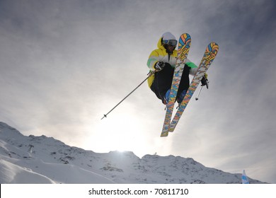 Extreme Freestyle Ski Jump With Young Man At Mountain In Snow Park At Winter Season