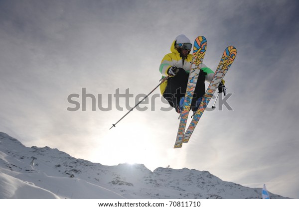 extreme freestyle ski jump with young man\
at mountain in snow park at winter\
season