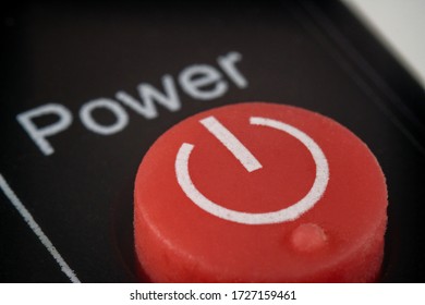 Extreme macro shot of a red power button on a remote control for a TV