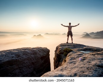 Extreme Man. Happy Trail Runner At Rocky View Edge Raised Arms To Sun Greeting. Nature Lover And Landscape Hiker.