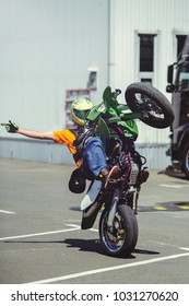 An Extreme Motorcycle On One Wheel Rides Along The Road. Motorcycle Willy.