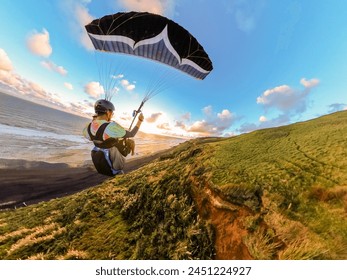 Extreme paragliding pilot soaring in the New Zealand beach at sunset. Adventure concept - Powered by Shutterstock