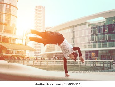 extreme parkour in business center. young boy performing some jumps from parkour discipline - Powered by Shutterstock